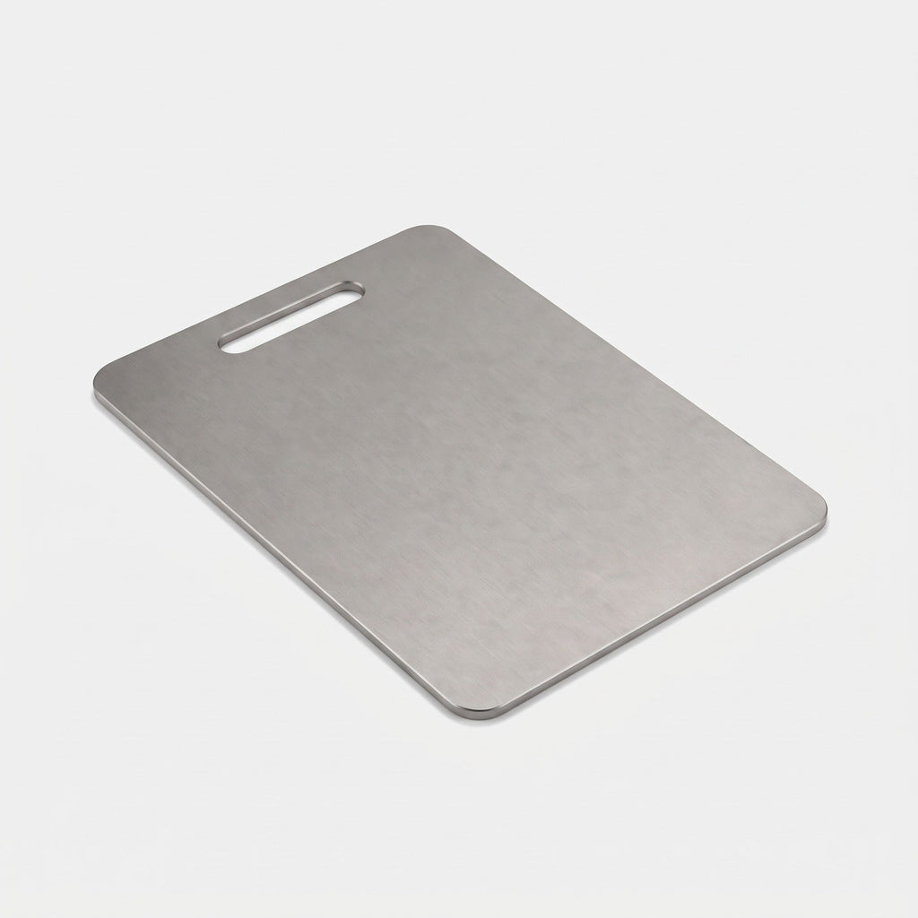 Titanium cutting board with handle cut-out on a light background