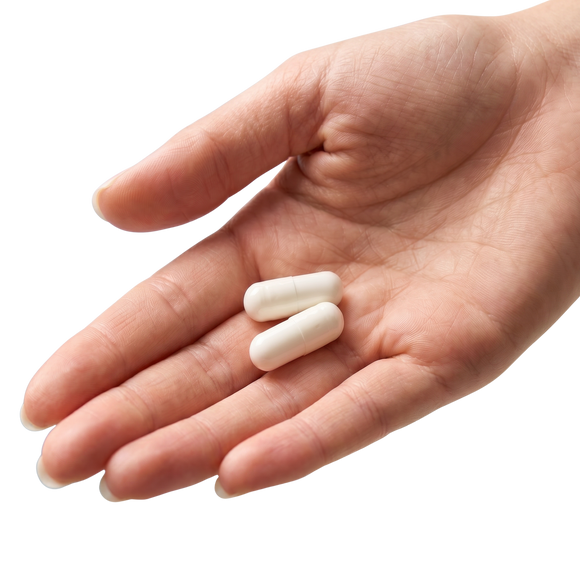 Two white capsules resting in an open hand