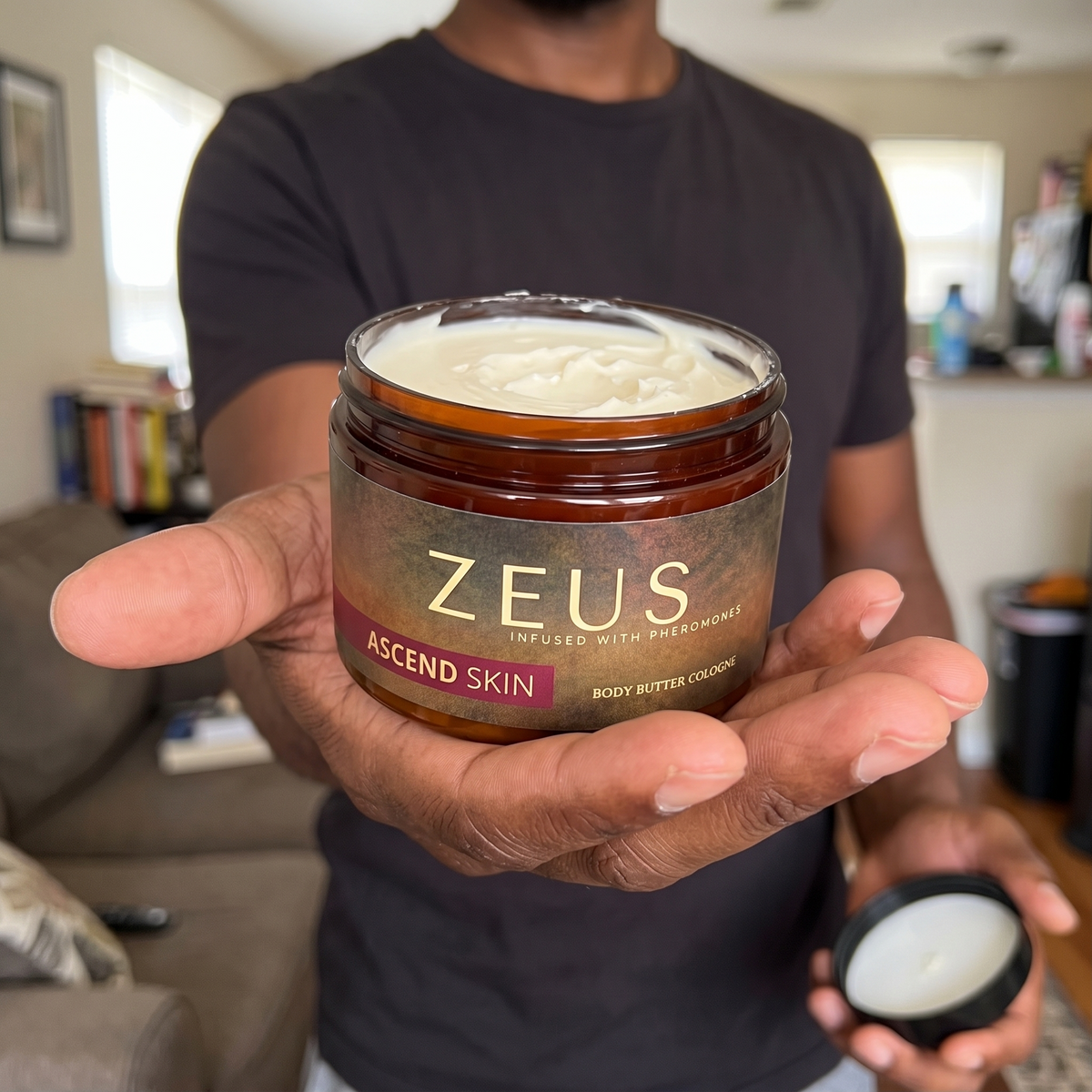 Man holding an open jar of scented body butter