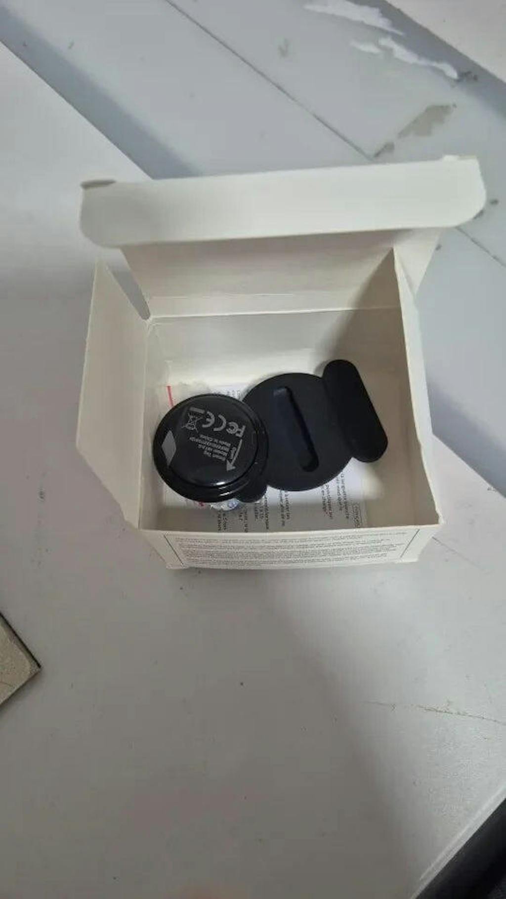 Tracker tag and protective sleeve in their box