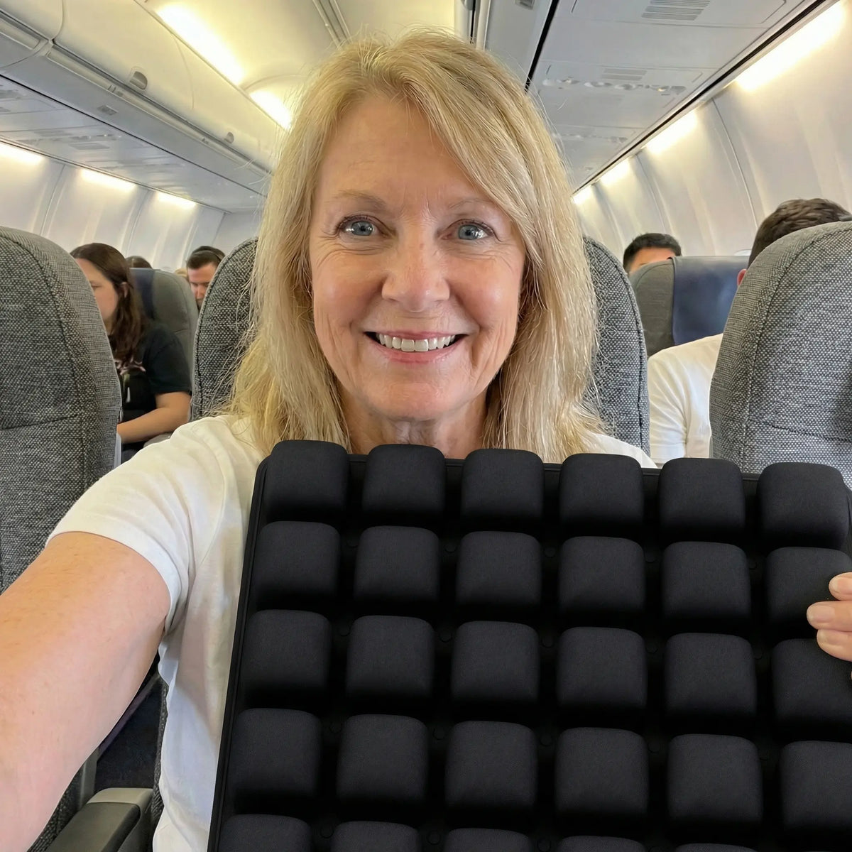 Woman taking a selfie with the cushion on a flight
