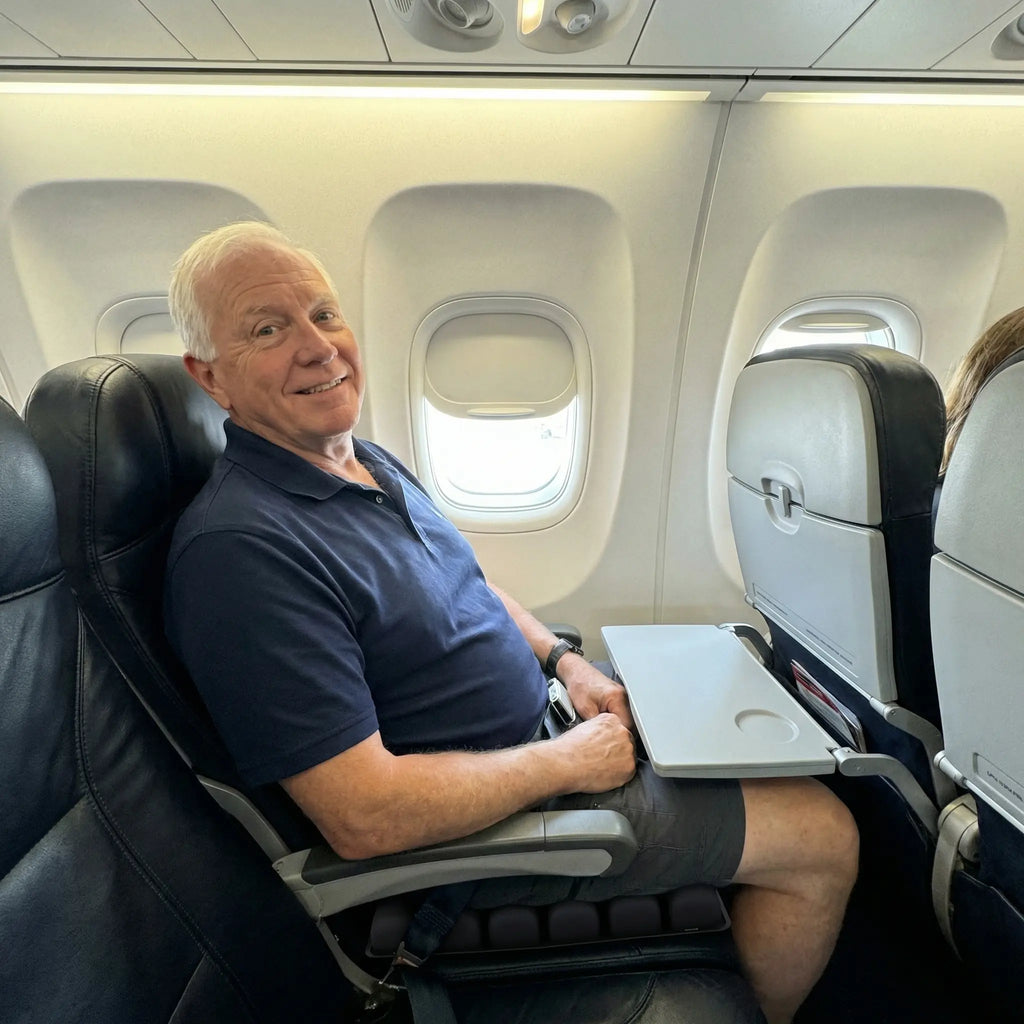 Older man sitting comfortably on the cushion in a plane seat