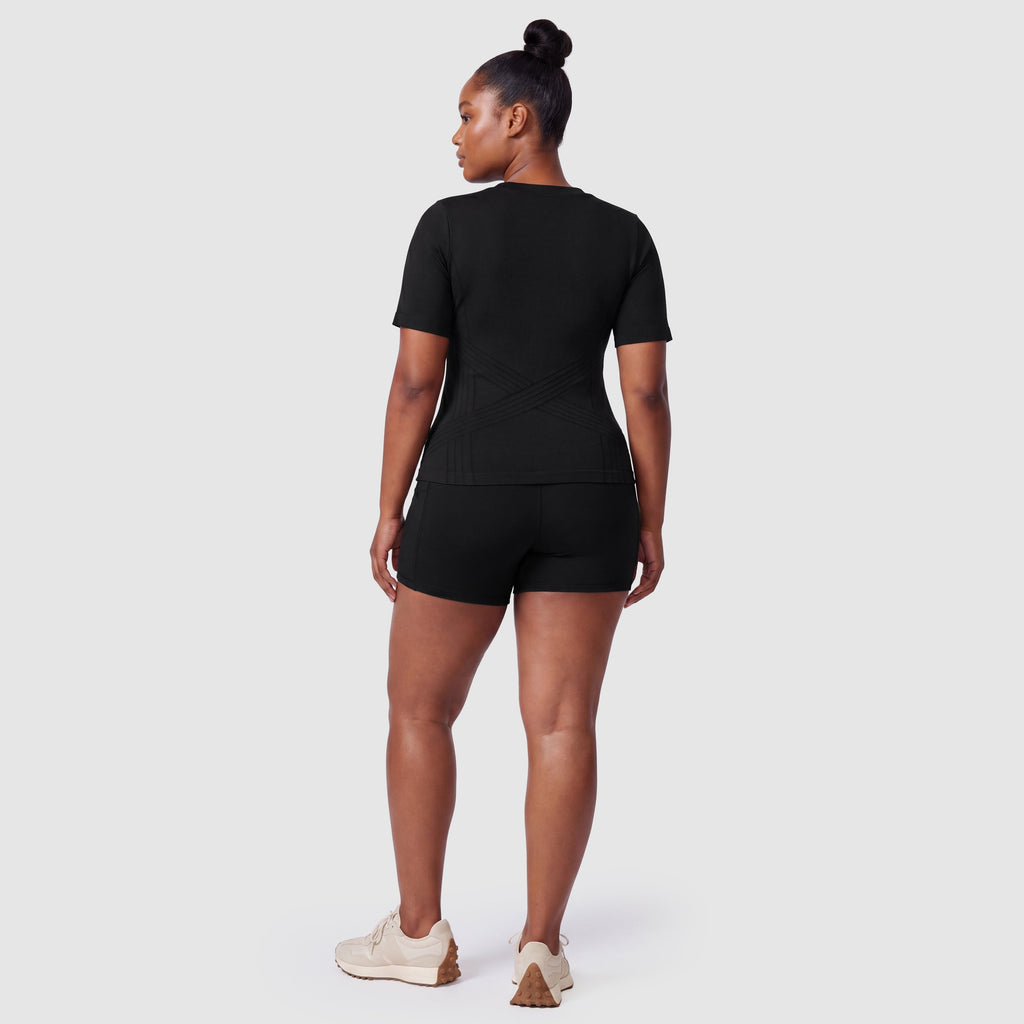 Woman wearing the Sculpt 3D™ compression tee in black, back view