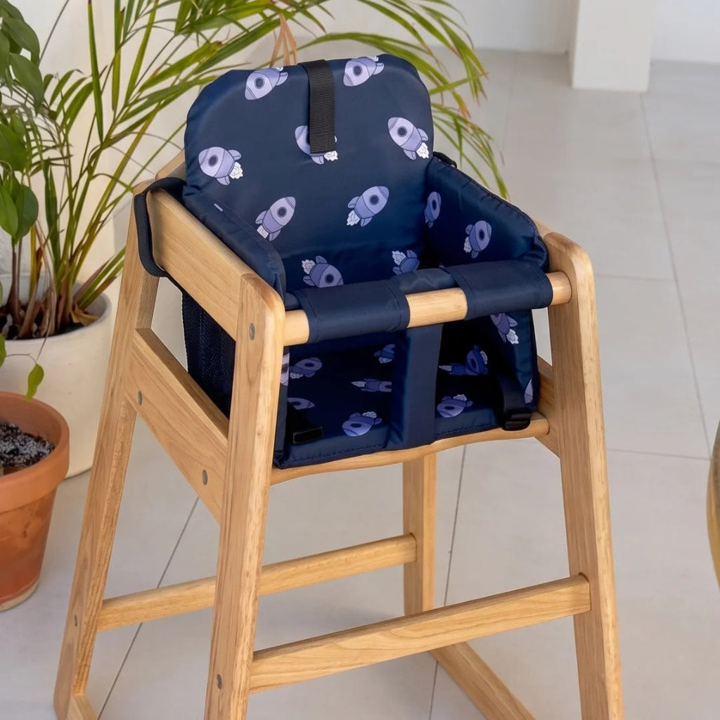 Navy space-print seat fitted to a wooden high chair