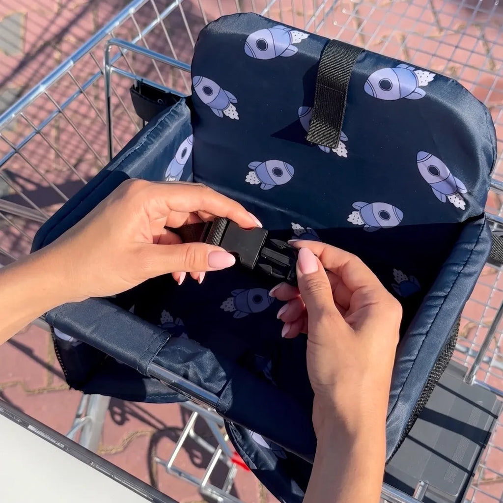 Parent closing the waist buckle on the seat in a cart