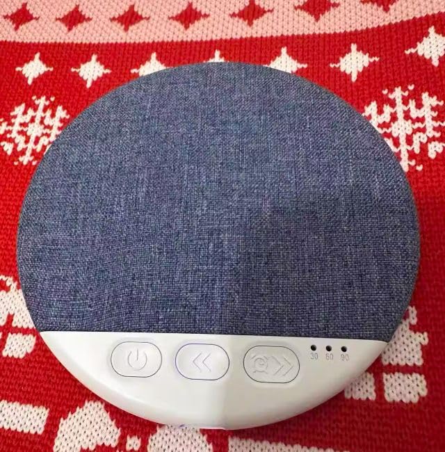 Pillow speaker showing the soft fabric top and control buttons