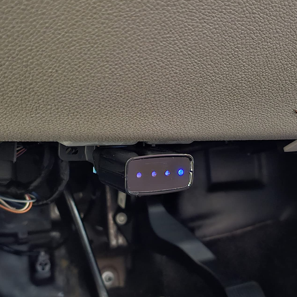Module plugged into the OBD-II port under the dashboard