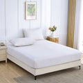 Grounding Bed Sheets fitted sheet on a white bed in a bright modern bedroom