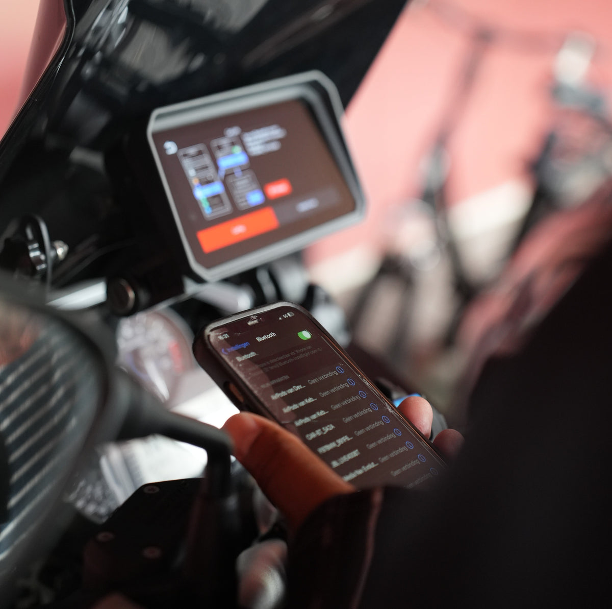 Rider pairing a smartphone with the motorcycle display