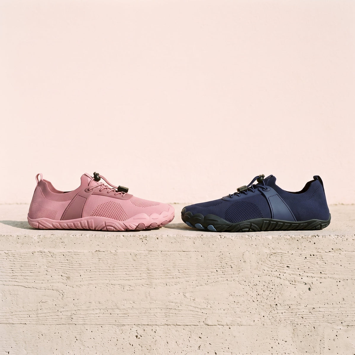 Barefoot shoes in coral pink and midnight blue side by side