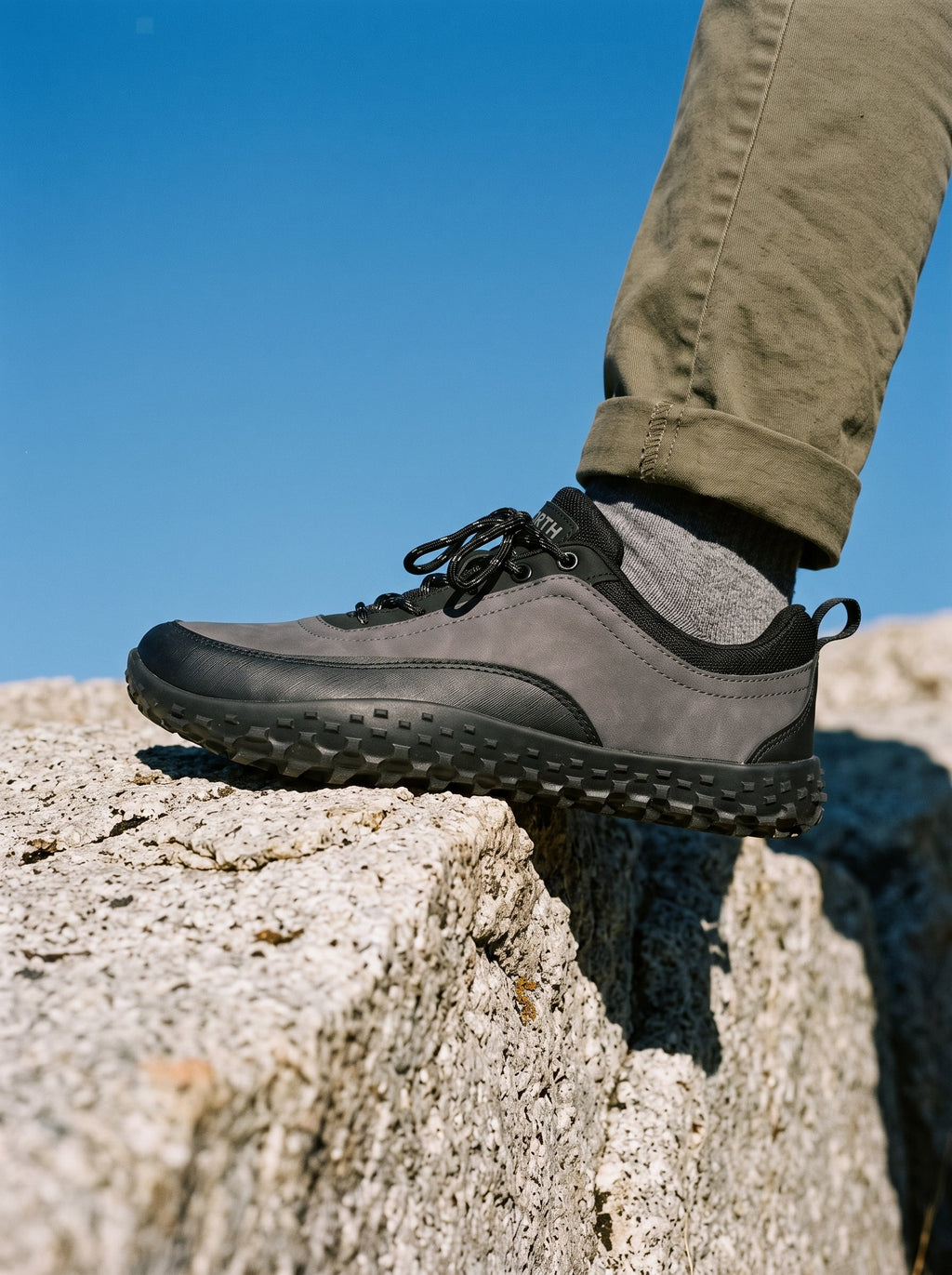 Shoe planted on a rock edge outdoors