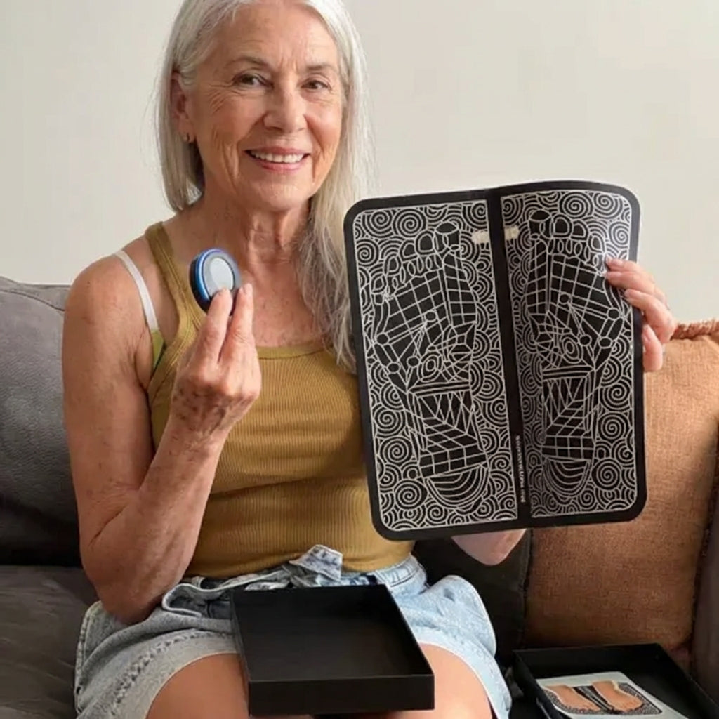 Smiling woman holding the EMS foot mat and its control unit