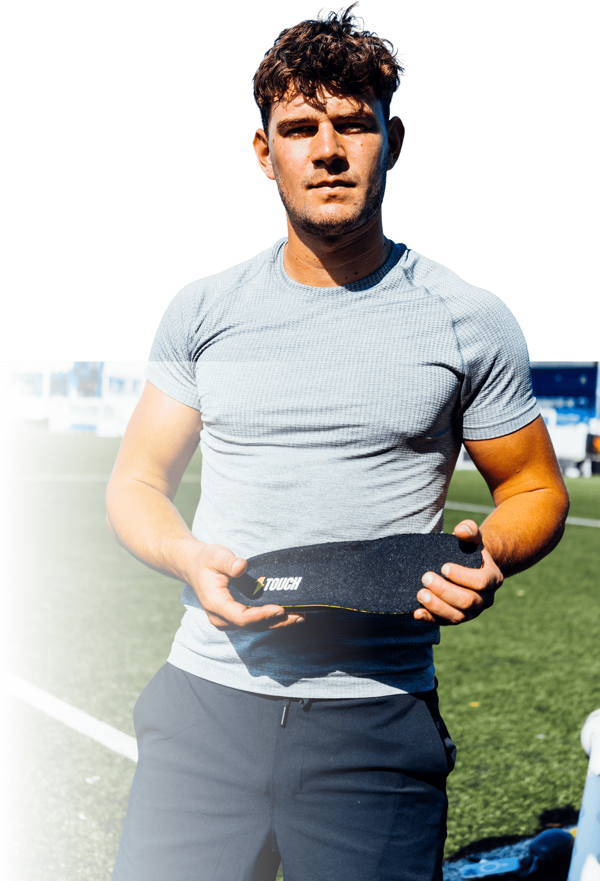 Player on a football pitch holding the carbon fibre insole