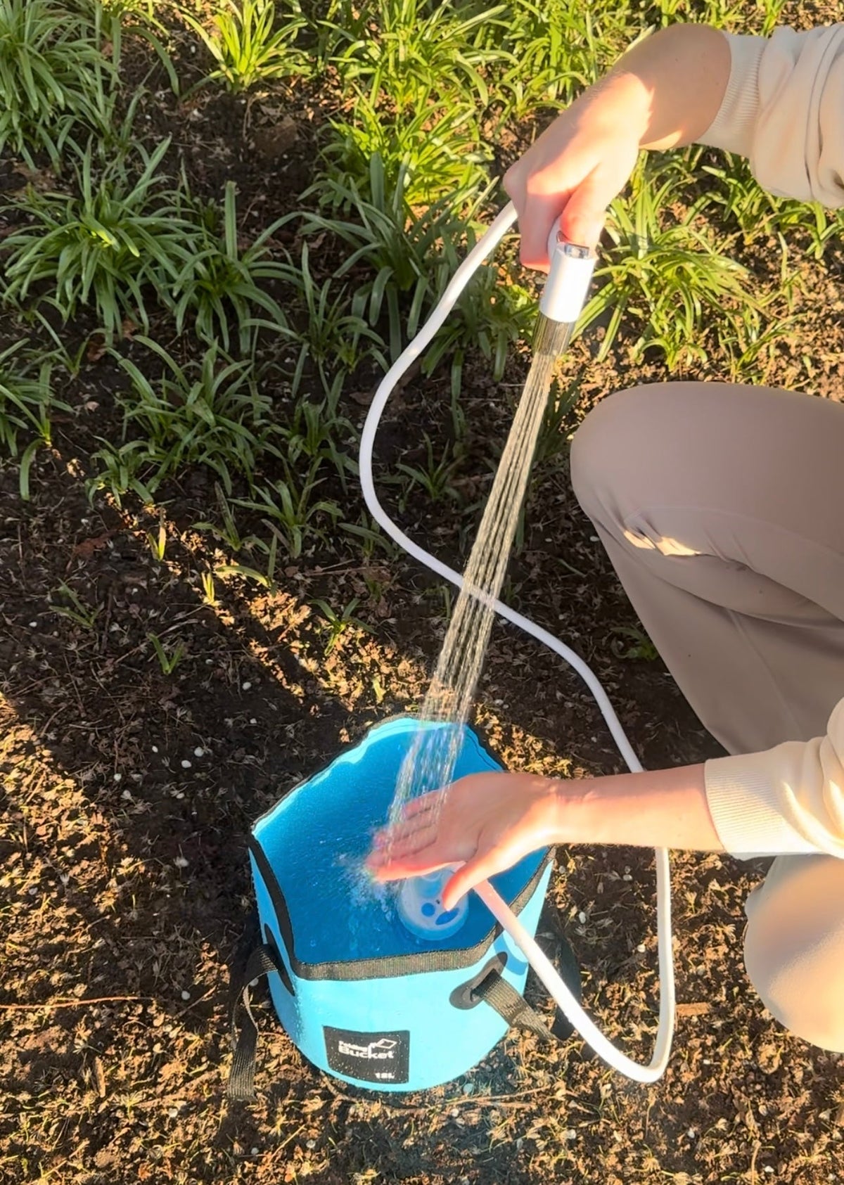Rinsing with the hand shower while the pump sits in a bucket