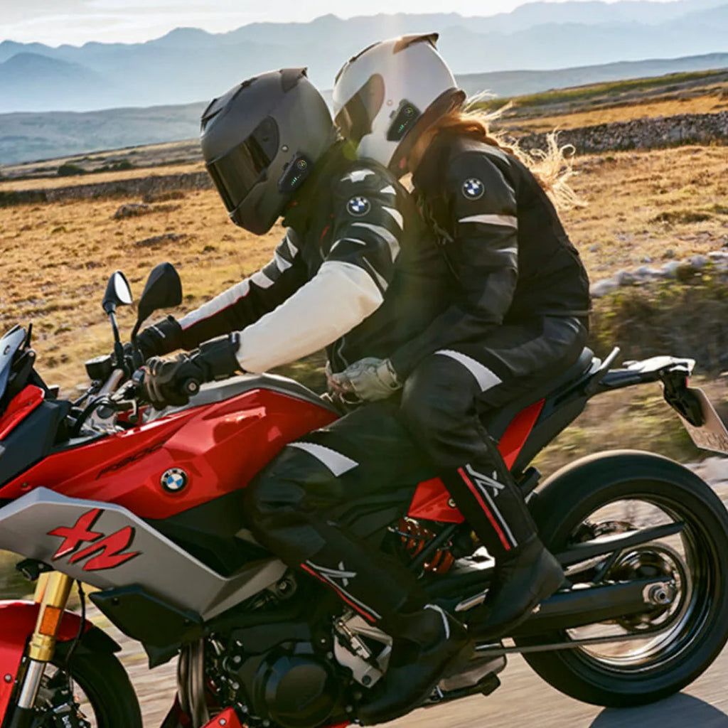 Rider and passenger on a motorcycle on a mountain road