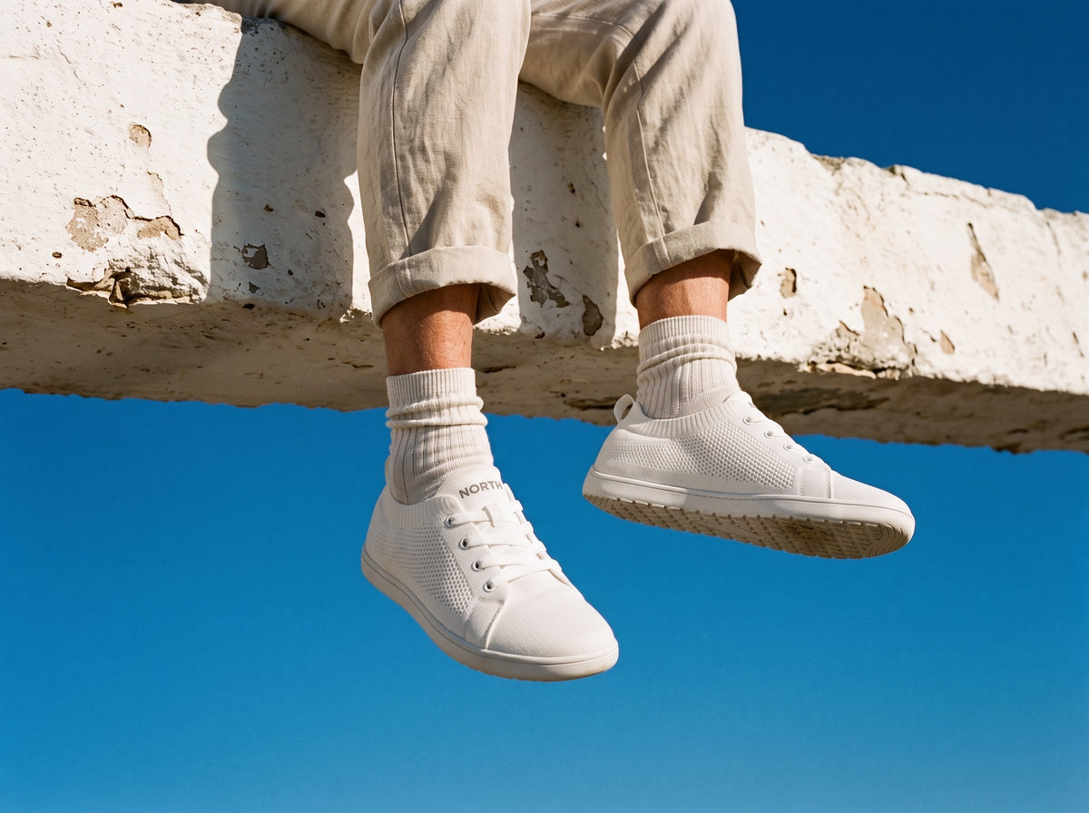 Relaxed feet in white sneakers in the sun