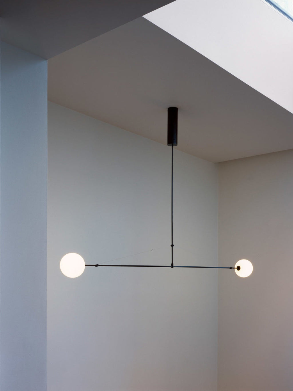 Minimalistisk mobil ljuskrona — opalvita munblåsta glasskärmar, patinerad mässing, svart