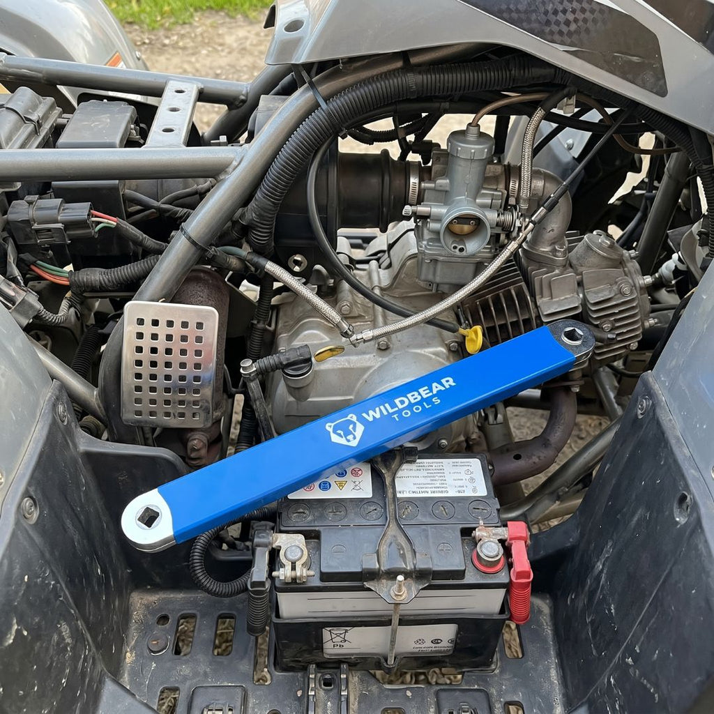 Offset extension reaching a bolt next to a vehicle battery