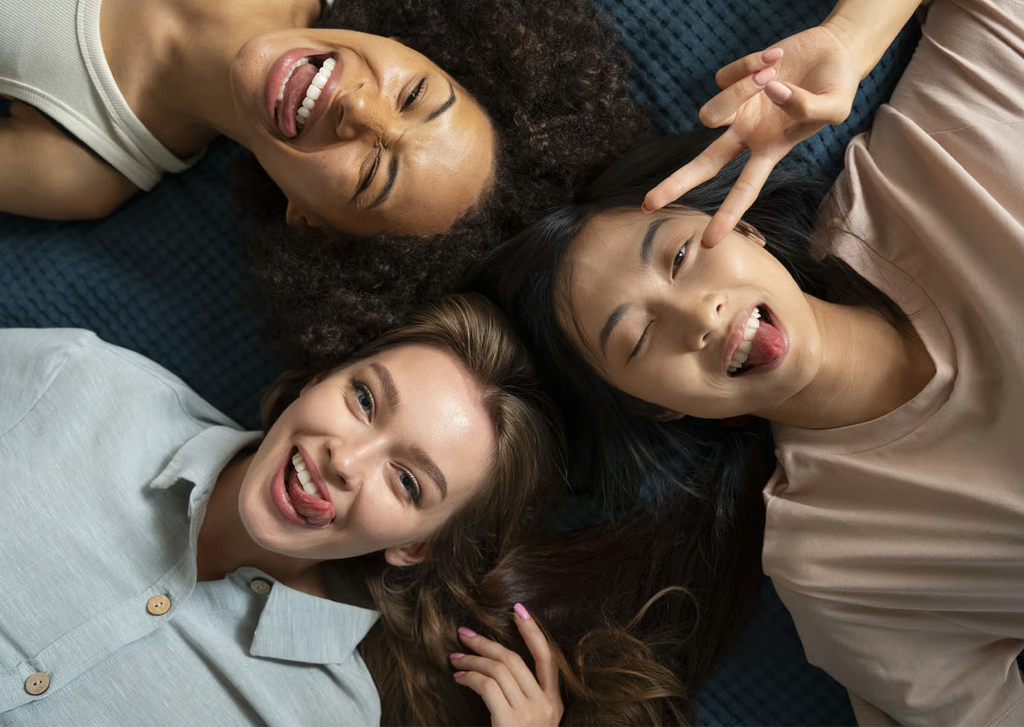 Group of smiling young women lying together