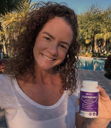Woman outdoors by a pool holding the supplement bottle