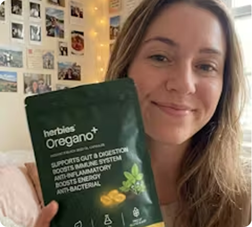 Woman at home holding the pouch of softgels