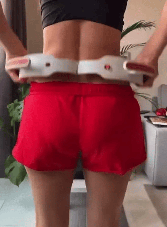 Woman rolling the massage ring around her waist
