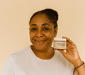 Smiling woman holding a jar of joint support capsules