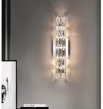 Applique da parete in cristallo con paralume trasparente e struttura in acciaio inox di Lumenara