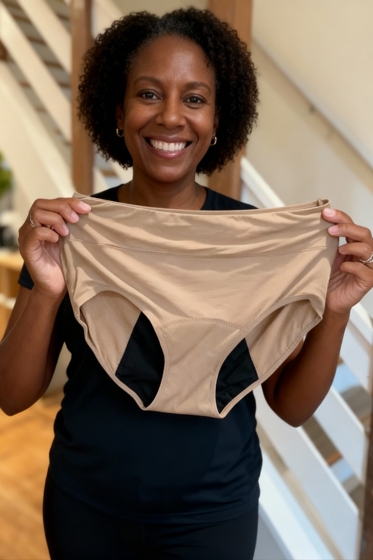 Woman showing the inside of beige leakproof briefs