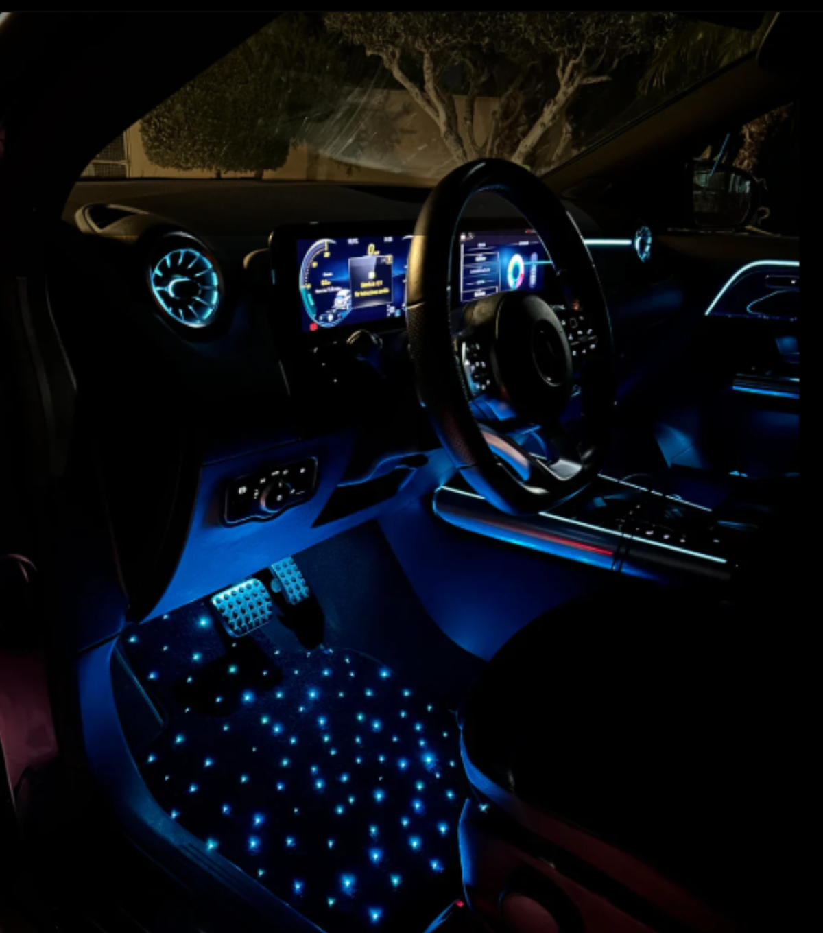 Driver footwell lit by blue LED star mats next to the pedals
