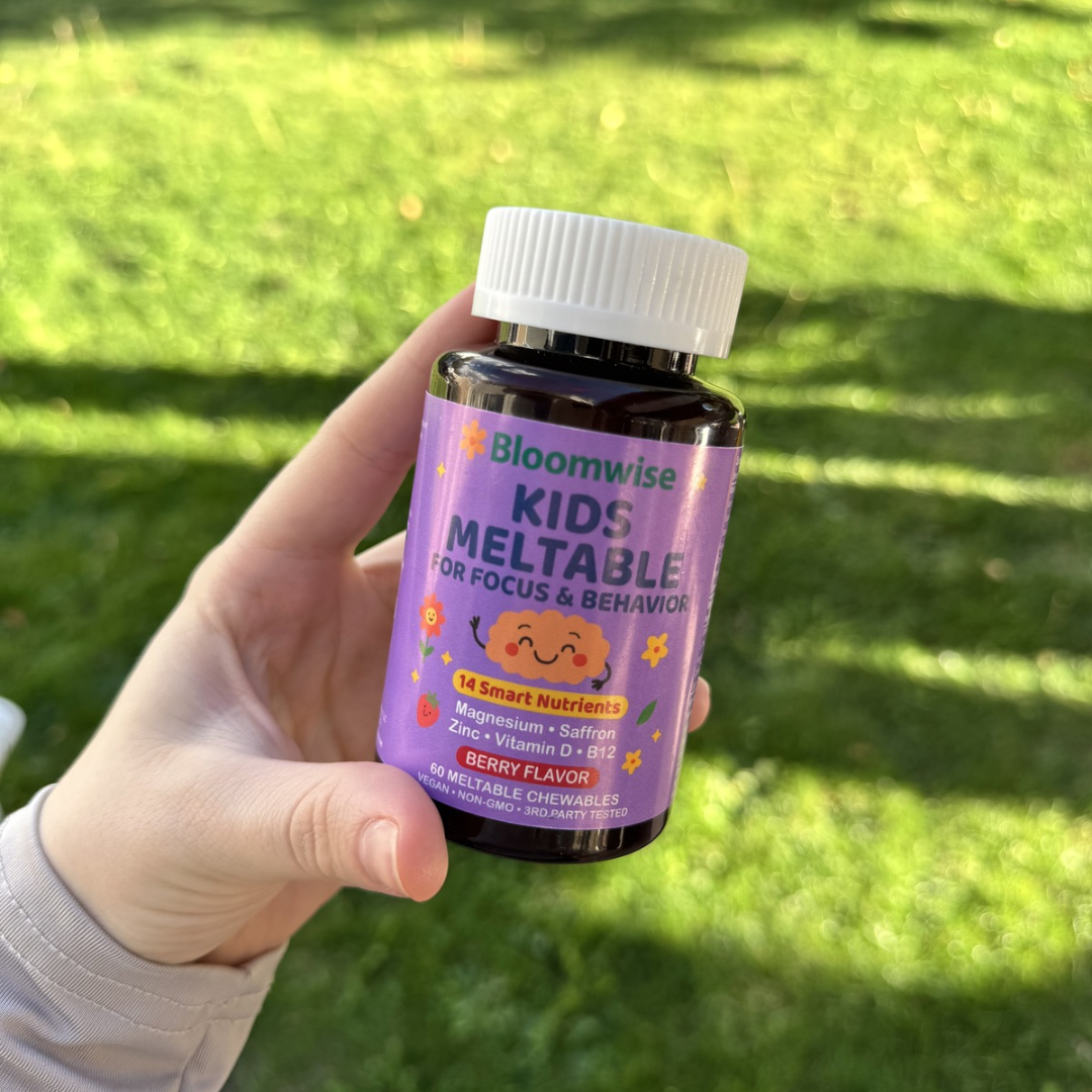 Bottle of meltable chewables held up outdoors on the grass