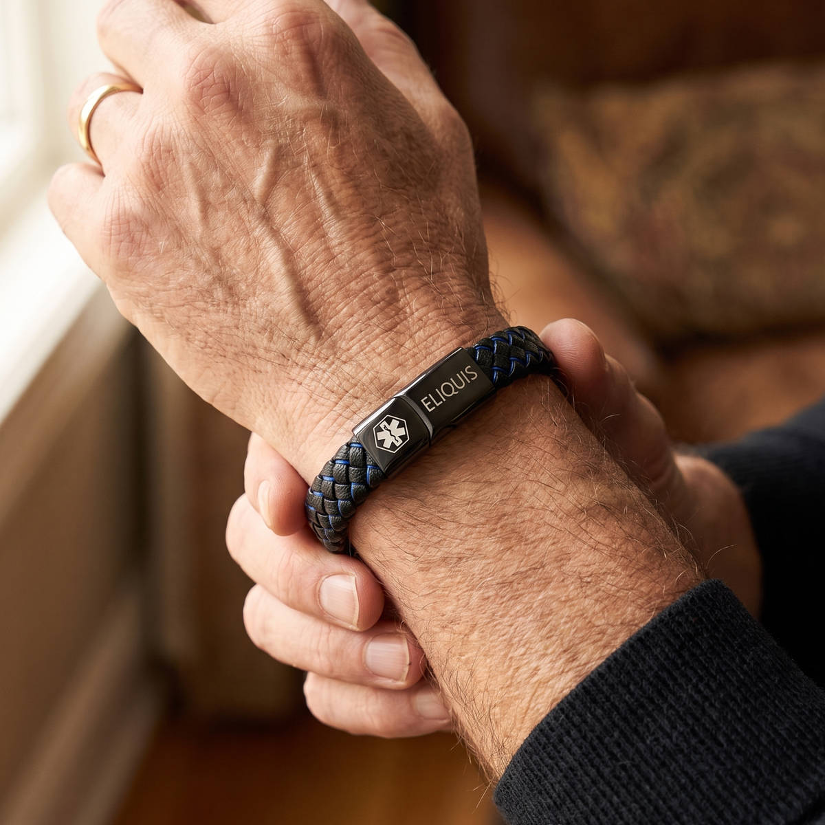 Eliquis medical alert bracelet in black and blue worn on the wrist