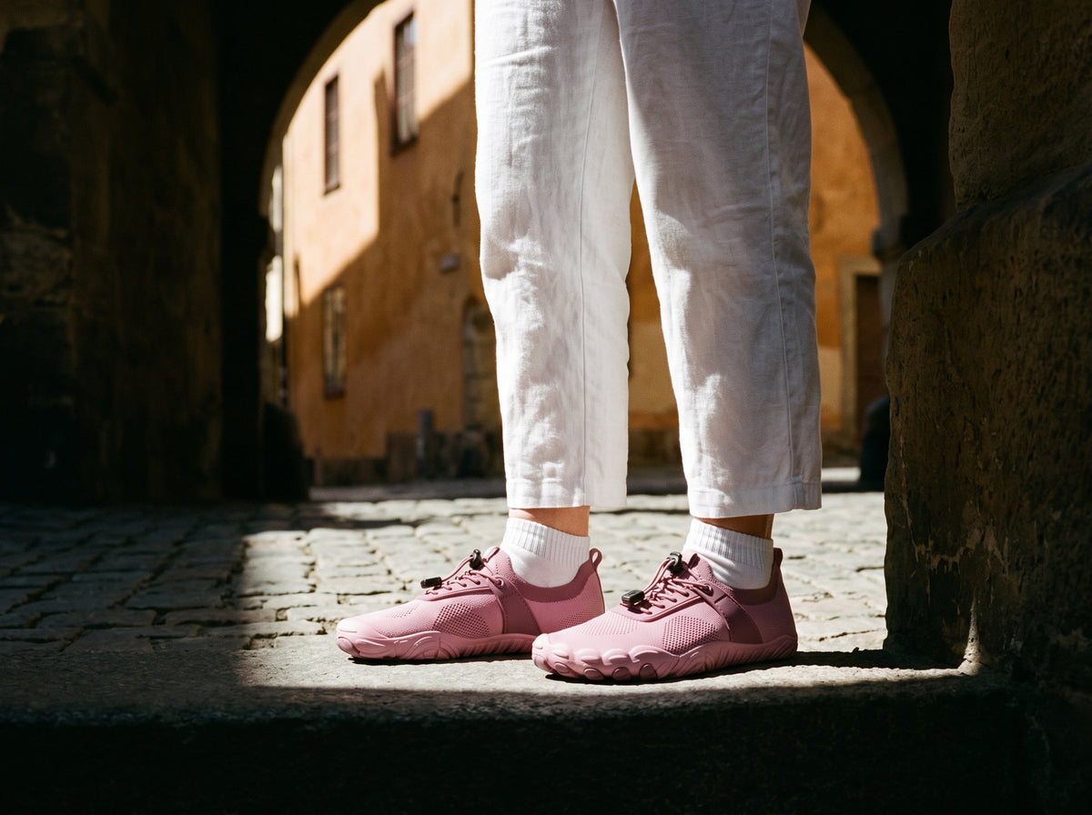 Coral pink barefoot shoes on a city street