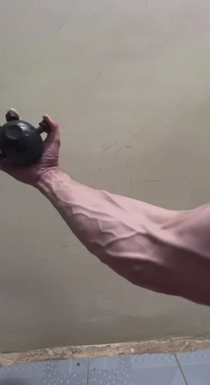 Arm holding the forearm training ball out to the side