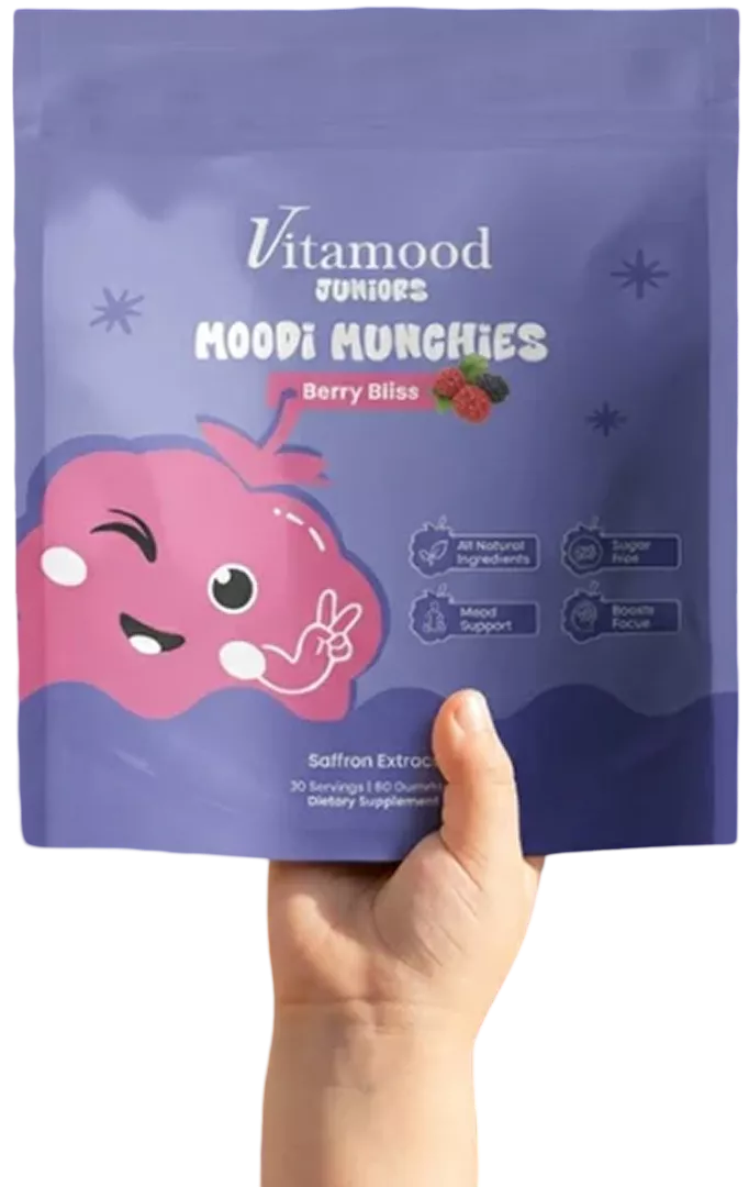Hand holding up the pouch of berry gummies