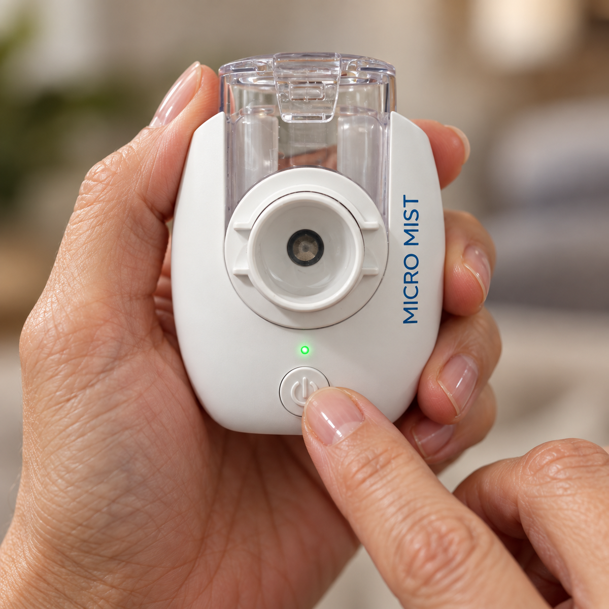 Thumb pressing the single power button on the nebulizer