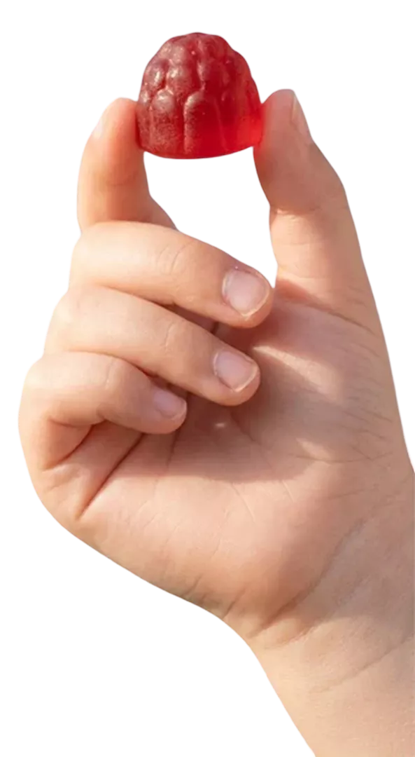 Child's fingers holding a red berry gummy