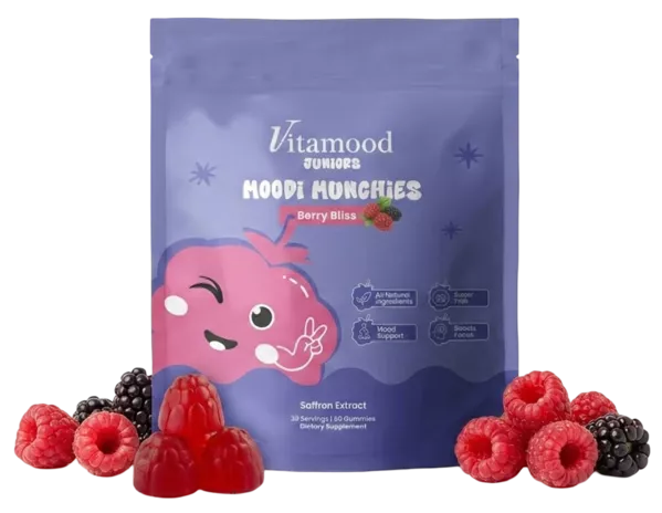 Pouch of berry saffron gummies surrounded by fresh raspberries and blackberries