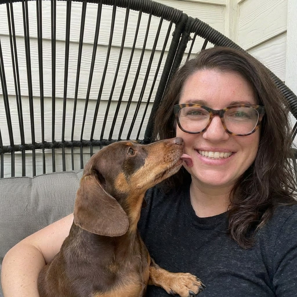 Woman getting a kiss from her dachshund
