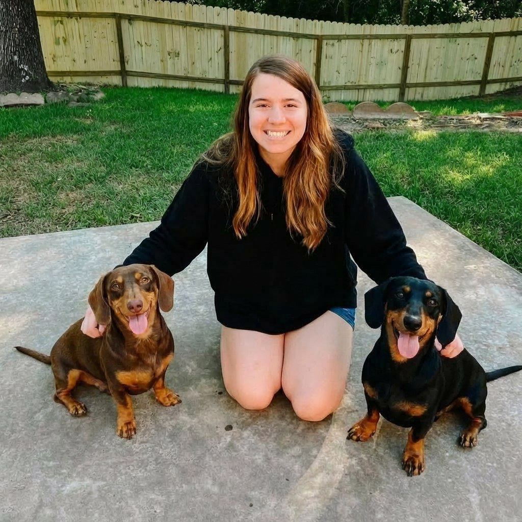 Woman sitting on the patio with two dachshunds