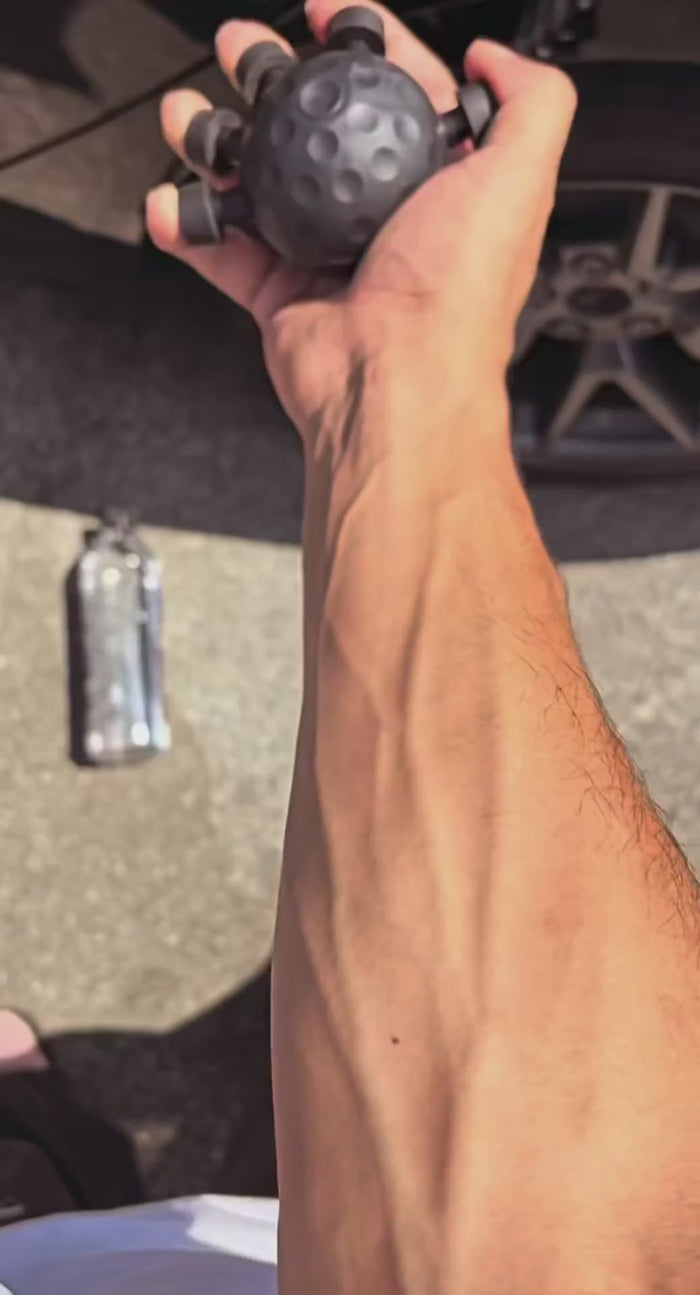 Hand gripping the training ball with the forearm extended