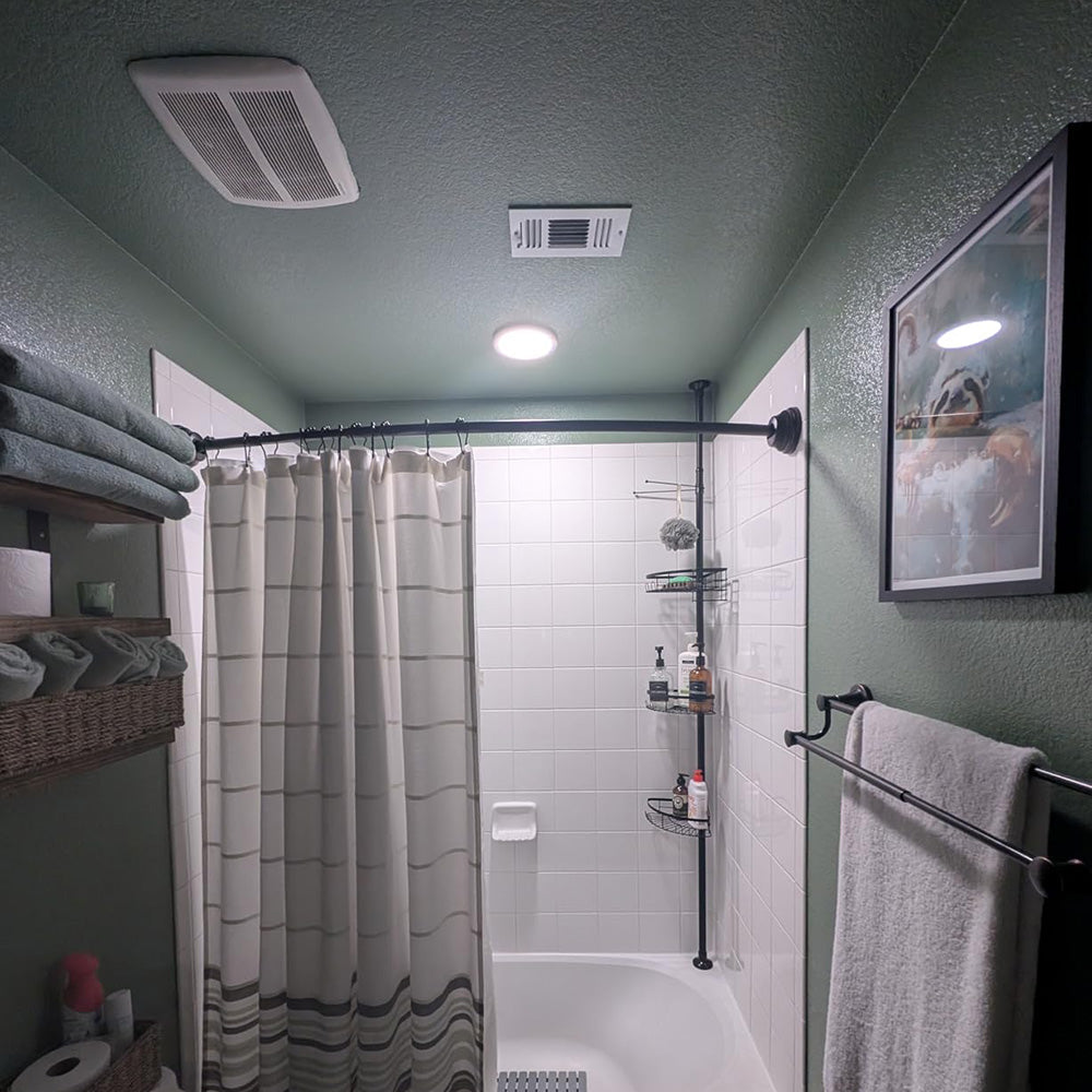 Bathroom with a round light above the shower