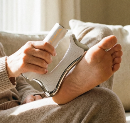 Massager being used on the sole of the foot