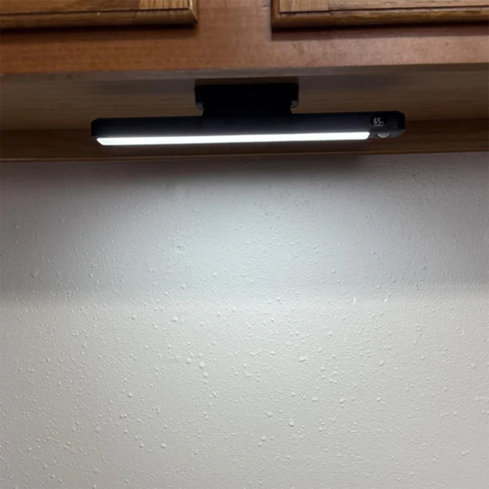 Light bar mounted under a kitchen cabinet lighting the counter