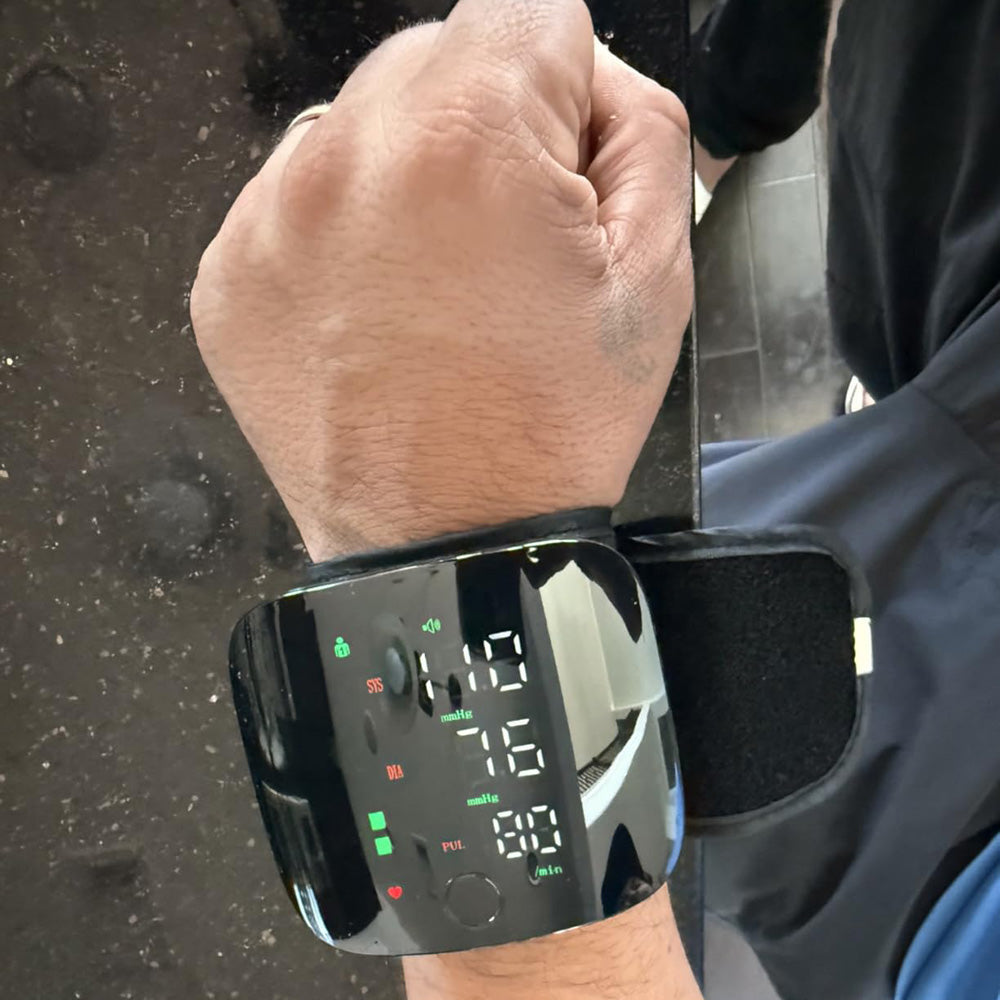 Wrist blood pressure monitor fitted on a wrist showing a reading