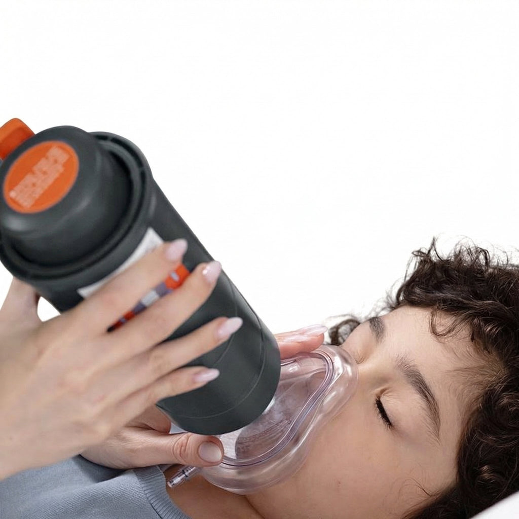 Adult holding the suction device with the mask over a child's nose and mouth
