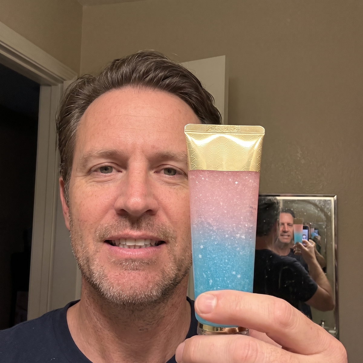 Man holding the whitening toothpaste tube at home