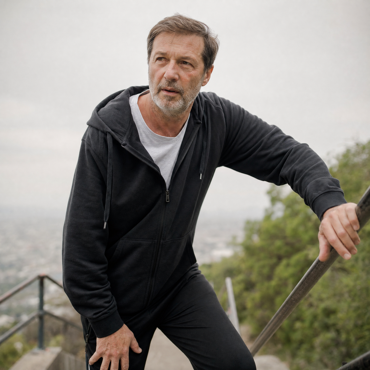 Mature man pausing on an outdoor hillside path