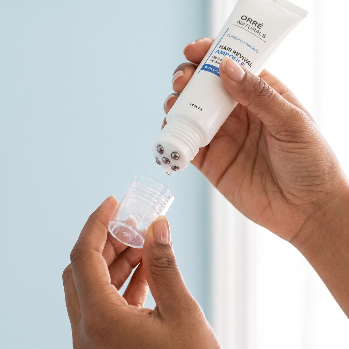 Hands twisting the cap off the ampoule tube