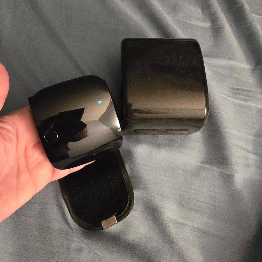 Compact wrist monitor held in the hand